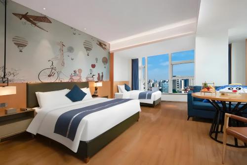 a bedroom with a large bed and a table at Changsha Rama-da by Wyndham Wuyi Square-Near Metro-Business Center in Changsha
