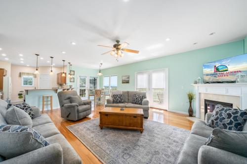 a living room with a couch and a table at Fairway Stay in Greenbackville