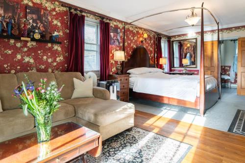 a living room with a bed and a couch at The Reynolds Mansion in Asheville