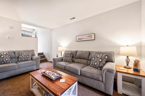 a living room with two couches and a coffee table at Fishhook Hideaway in Chincoteague