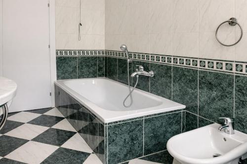 a bathroom with a bath tub and a toilet at Iris Viola in Bagno a Ripoli