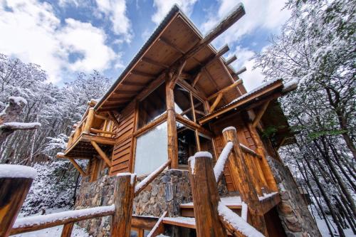 a tree house in the woods in the snow at Patagonia Villa in Ushuaia
