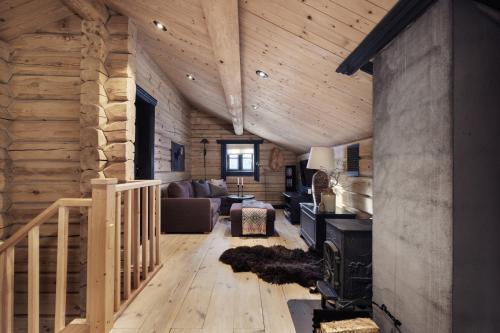 a living room with a staircase in a log cabin at Utsikten in Vågsli