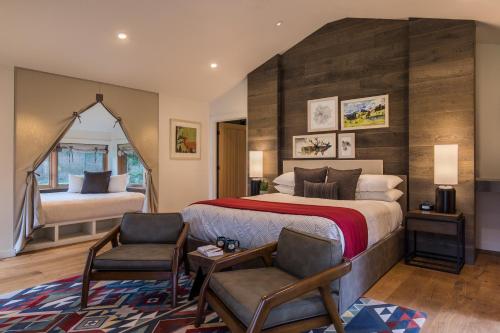 a bedroom with a large bed and two chairs at Skamania Lodge in Stevenson