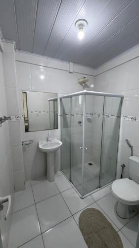 a bathroom with a shower and a toilet and a sink at Ed. Odilon Vieira ap.205 in Vitória da Conquista
