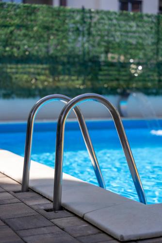 an empty mattress next to a swimming pool at Vila Katalina Spa & Resort in Zlatibor
