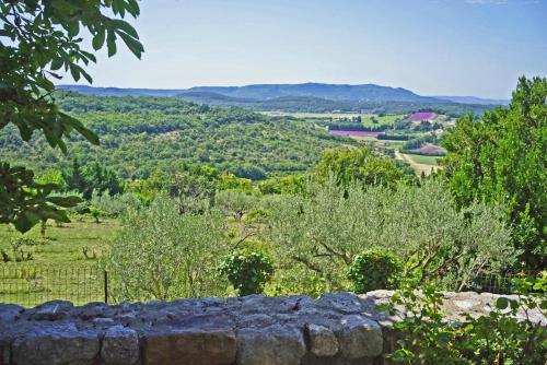 a view of a valley from a stone wall at Mas Antonin in La Garde-Adhémar