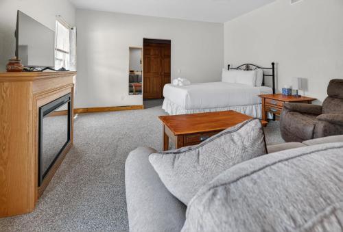 a living room with a couch and a tv and a bed at 1BR Mountain View Studio with Fireplace Deck Views in Fort Collins