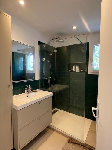 a bathroom with a sink and a shower at House with large garden Audenge in Audenge