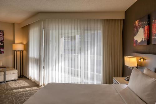 a bedroom with a bed and a large window at Delta Hotels by Marriott Montreal in Montreal
