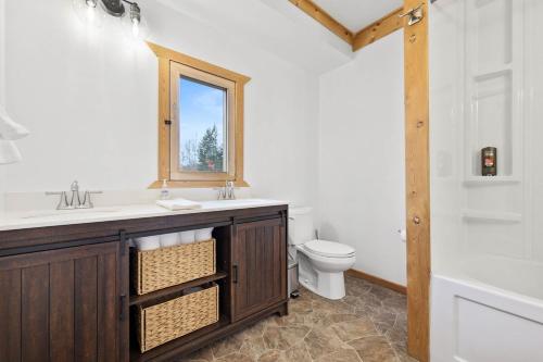 a bathroom with a sink and a toilet at Cabin on Private 8-acre Lake in Clearwater