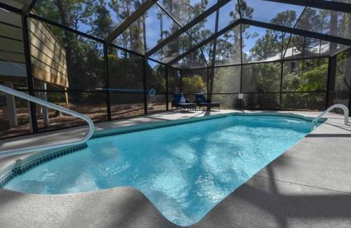 a swimming pool in a house with a glass wall at St George Island Bay Front Pool in St. George Island