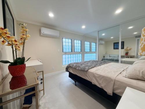 a bedroom with a bed and a large mirror at Sunset Beach Paradise Home in Sunset Beach