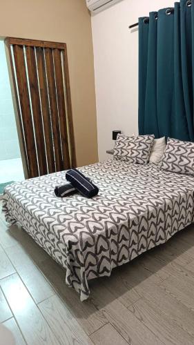 a bed in a room with at Résidence LE MÄYSA in Sada