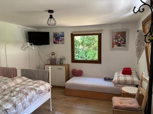 a bedroom with a bed and a window at Lawendowa Weranda in Krasnobród
