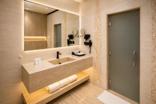 a bathroom with a sink and a mirror at Luxury Night Hotel Al Yasmin in Riyadh