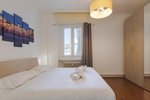 a bedroom with a bed with two stuffed animals on it at Free WiFi Netflix Settefontane Elegant Suite in Trieste