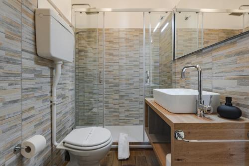 a bathroom with a toilet and a sink at Free WiFi Netflix Settefontane Elegant Suite in Trieste