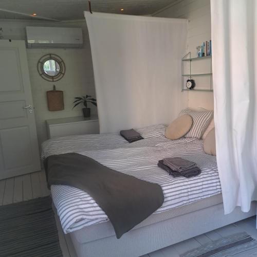 a bed in a bedroom with two bags on it at Gästhus öppen planlösning in Oskarshamn