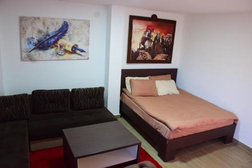 a living room with a bed and a couch at Komitski Konak & Spa in Plešanci