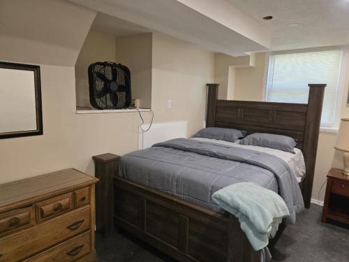 a bedroom with a bed and a clock on the wall at Beach Vacation Home in Rochester