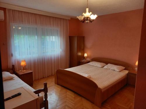 a bedroom with two beds and a window at Villa Marija in Struga