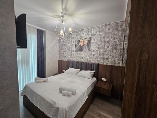 a bedroom with a large bed with white sheets at BST Batumi Leo in Angisa