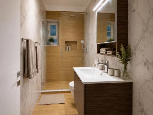 a bathroom with a toilet and a sink and a shower at Ria's Garden House in Kassiopi