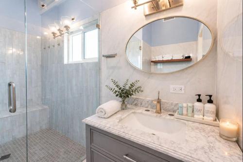a bathroom with a sink and a mirror and a shower at Southside Serenity of St Croix in Christiansted