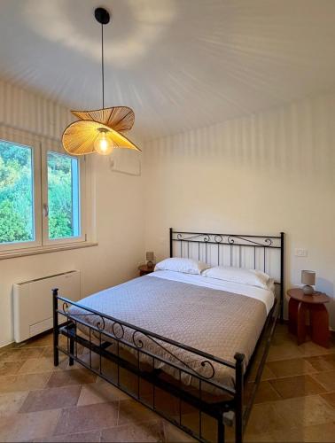 a bedroom with a bed and a chandelier at Tenuta Piccioni Relais,Pool and Spa in Colonnella