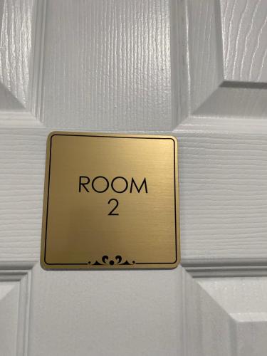 a sign on a door that reads room at Sakisa International in Waldorf