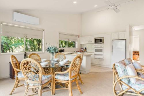 a kitchen and dining room with a table and chairs at Harbour Creek in Ulladulla