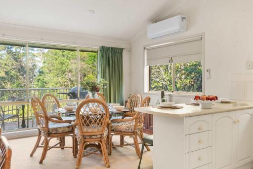 a kitchen and dining room with a table and chairs at Harbour Creek in Ulladulla