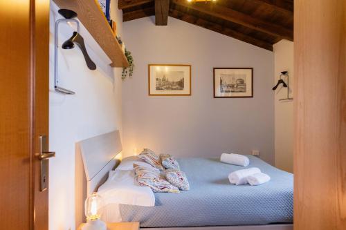 a bedroom with a blue bed with pillows on it at Villa Sanziana in Menaggio
