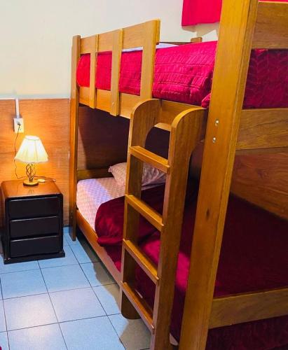 two bunk beds in a room with a lamp at KORICANCHA in Lima