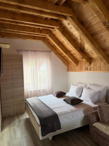 a bedroom with a large bed and a window at Lux Studio Apartments in Žabljak