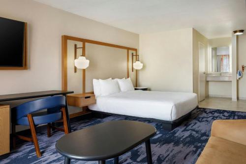 a hotel room with a bed and a desk at Fairfield Inn by Marriott Ponca City in Ponca City