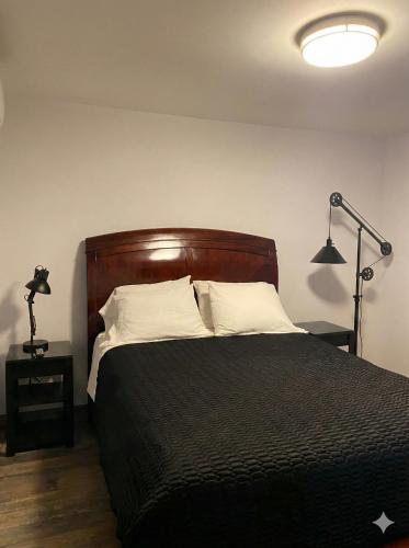a bedroom with a black bed with white pillows at Hotel y Suites Panda in San Luis Río Colorado