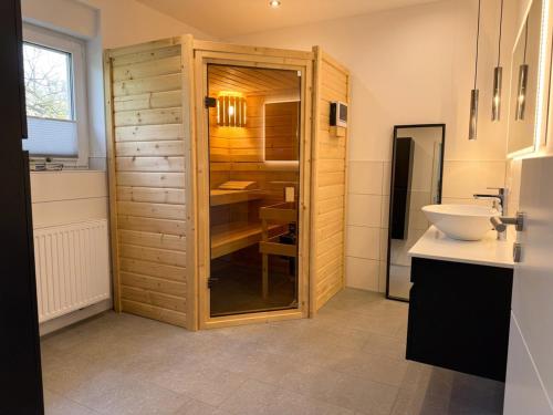 a bathroom with a sink and a cabinet with a mirror at Apartment Jonte im Dangaster Nest in Varel