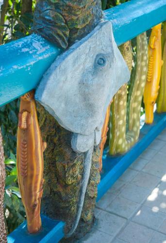 a statue of a fish on a blue bench at Hotel Los Corales in West End