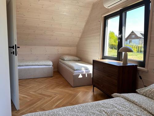 a room with two beds and a window at Pięć Sosen in Wiele