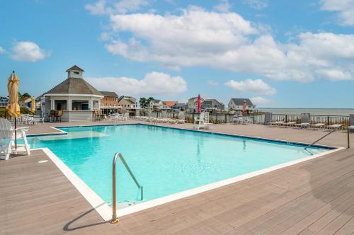 a large swimming pool in a resort with a deck at Hidden Gem in Greenbackville