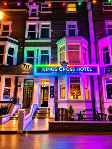 a kings cross hotel is lit up at night at The Kings Cross Hotel in Blackpool