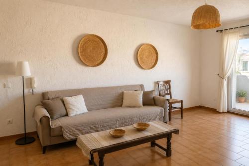 a living room with a couch and a table at Domo e Mare in Valledoria
