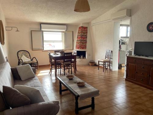 a living room with a couch and a table at Domo e Mare in Valledoria