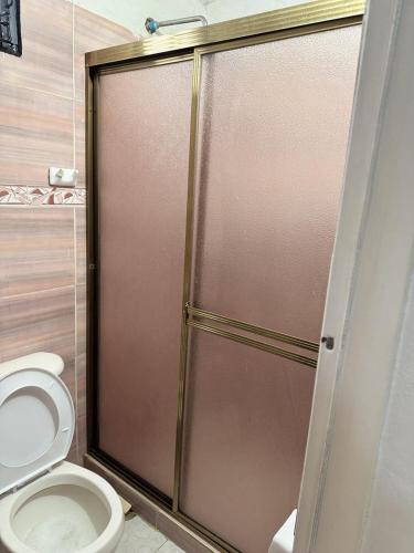 a bathroom with a shower stall with a toilet at Cabaña destino 11 in Mérida