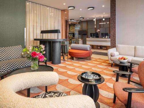 a lobby with couches and chairs and a table at Hotel Mercure Wien City in Vienna