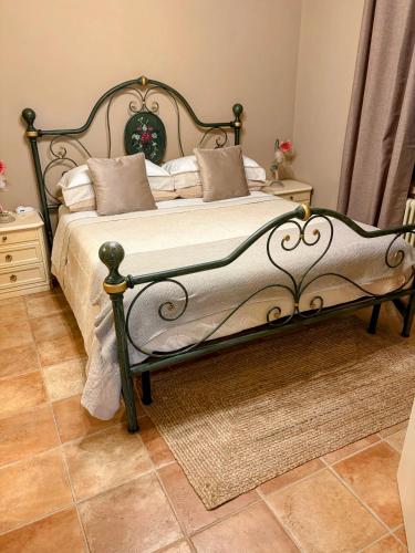 a bedroom with a bed with a metal frame at Il Vialetto in Cannara