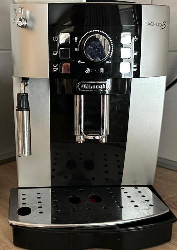 a coffee maker is sitting on top of a table at Kings main square Apartment - AC - Balcony - Coffee Machine - Washer - Kitchen- Parking in Poprad