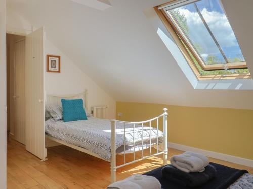 a bedroom with a bed and a skylight at Pottery Barn in Branscombe